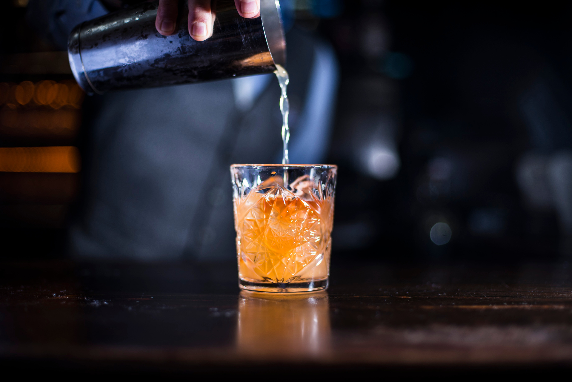 Bartender pouring old fashioned cocktail